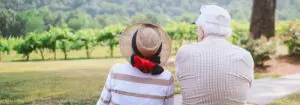 Elderly couple sitting together outside