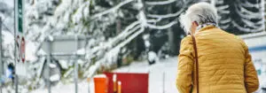 Elderly woman walking outside in winter