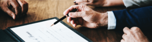 man signing document