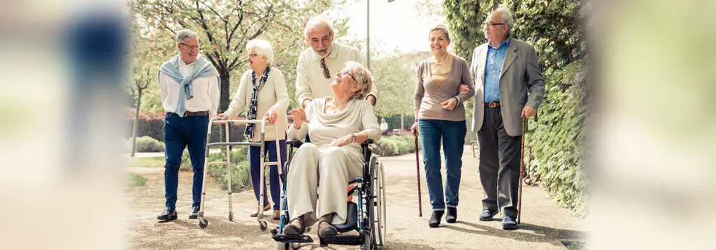 Group of elderly people walking down street