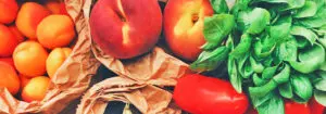 Fruits and vegetables in brown paper bags