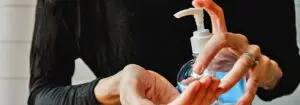Woman pumping hand sanitizer