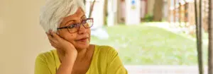 Senior woman leaning her head against her hand