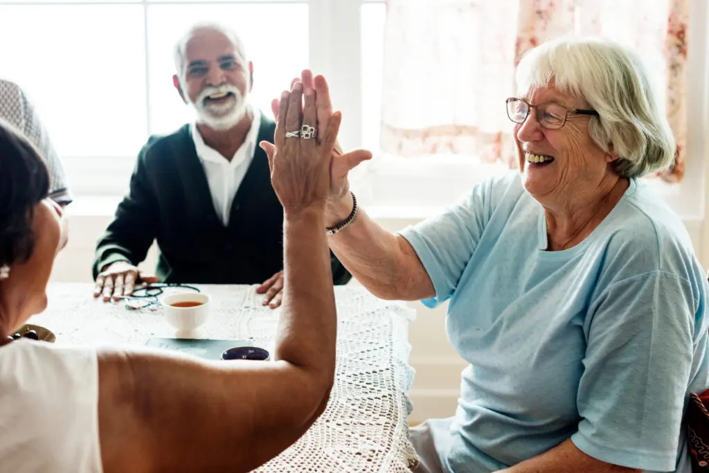 Two senior women giving each other high fives