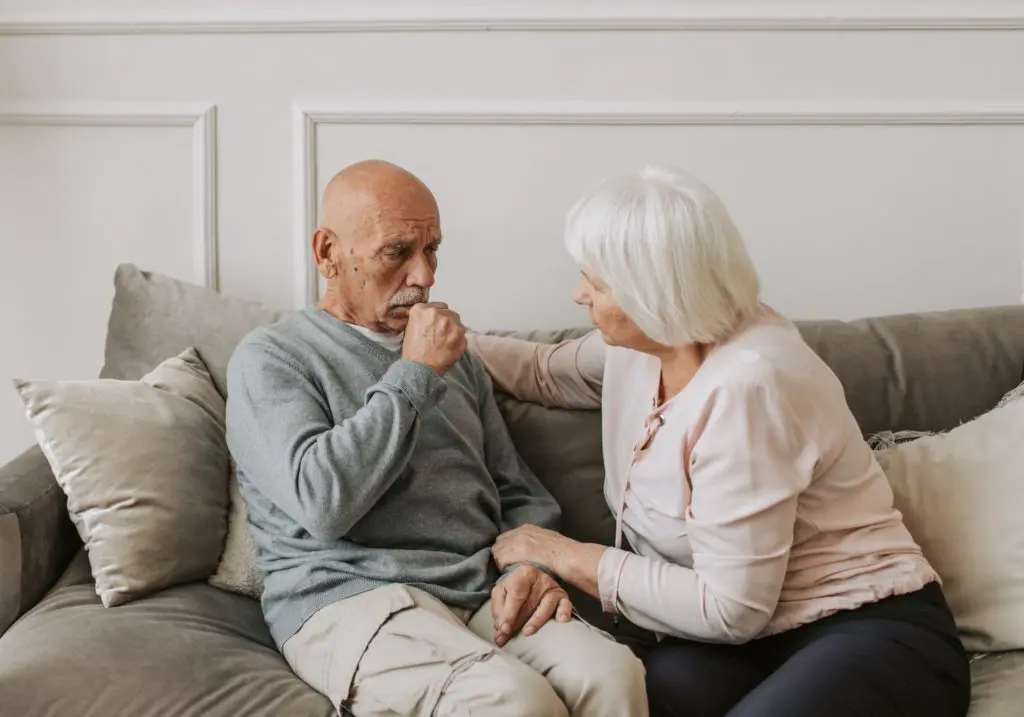 old man and woman on couch