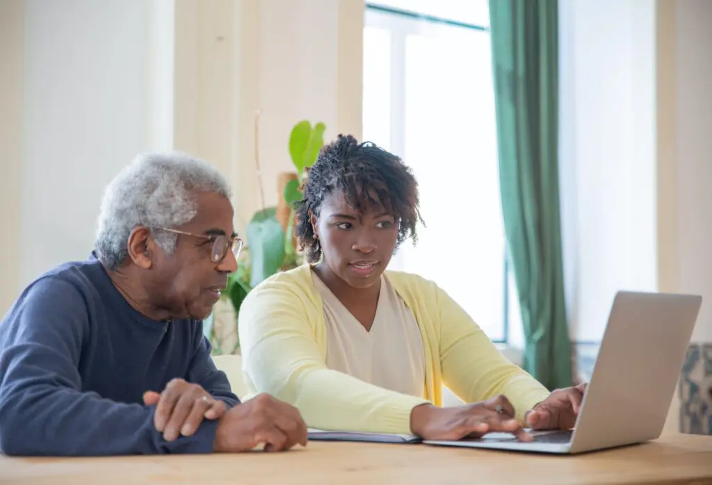 old man and daughter on laptop