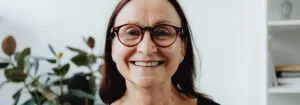 An Elderly Woman Smiling while Wearing Eyeglasses