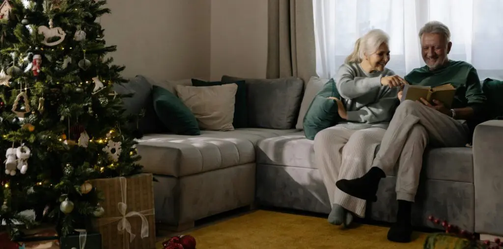 Woman in Gray Sweater Sitting on Gray Couch
