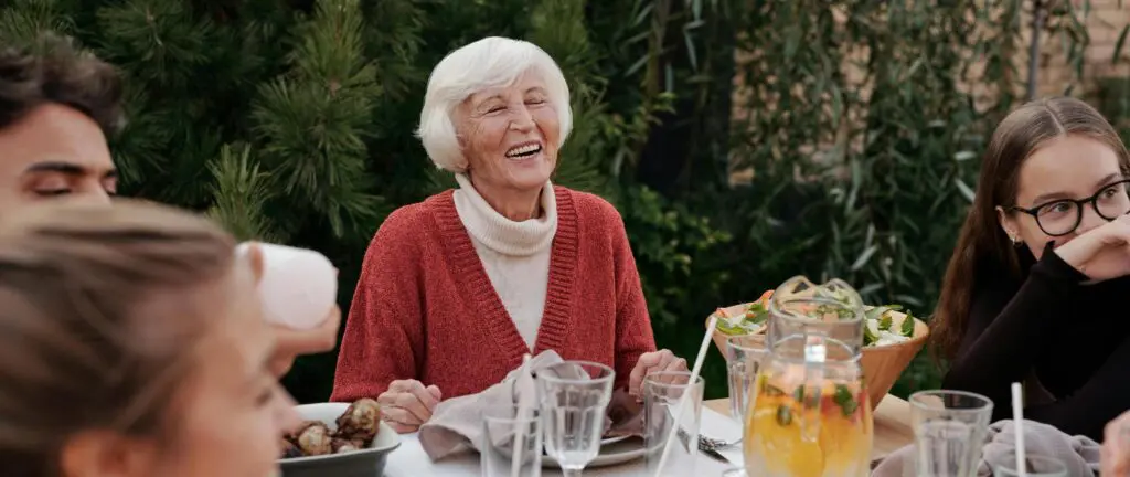 woman-smiling-at-dinner | McGregor PACE woman smiling at dinner with family
