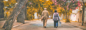 Elderly couple walking down street