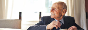 elderly man smiling at table