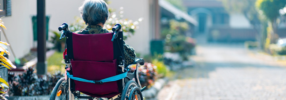 elderly woman in wheelchair outside