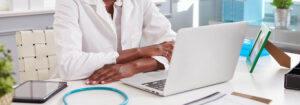 Female doctor on laptop at desk