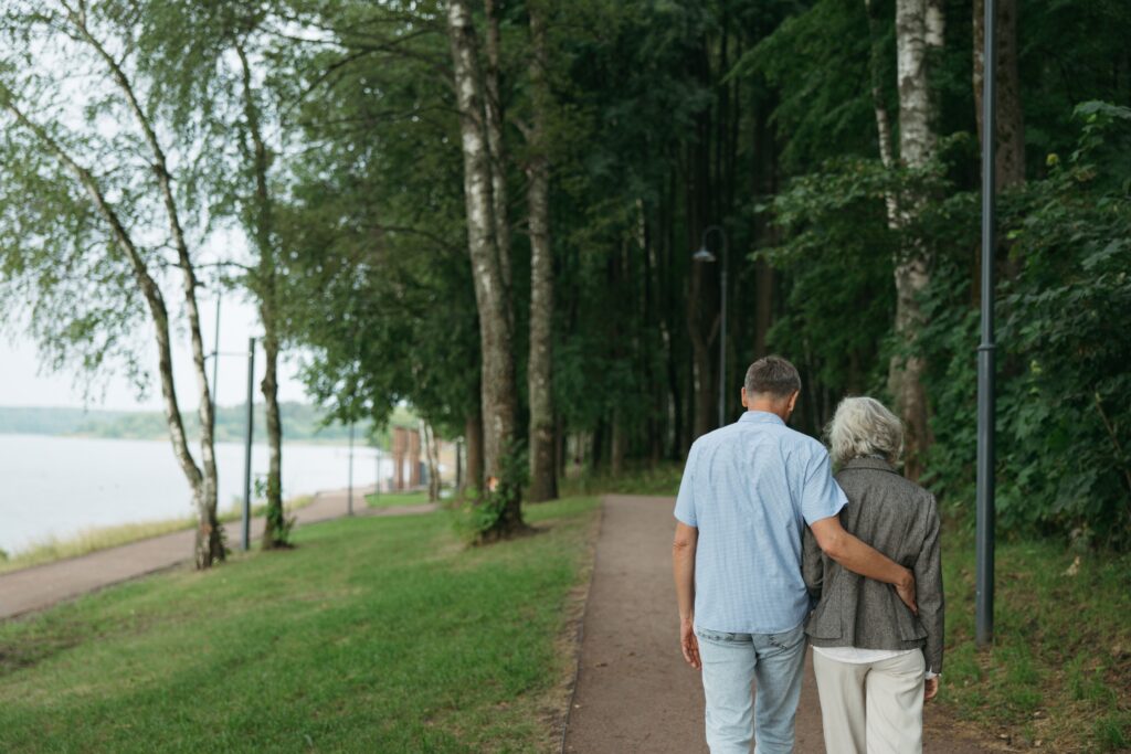 Elderly couple walking together in park