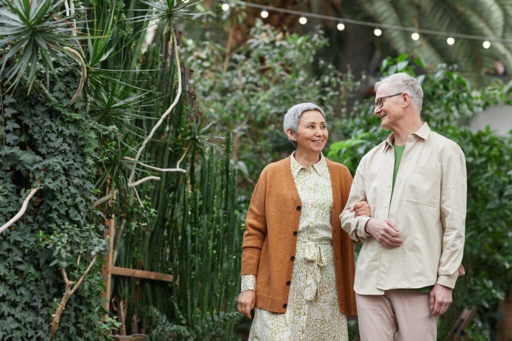 Senior couple walking in garden