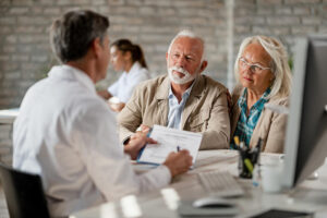 Elderly couple speaking with healthcare professional