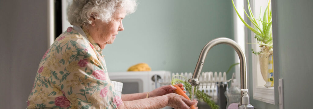 Senior woman washing carrots