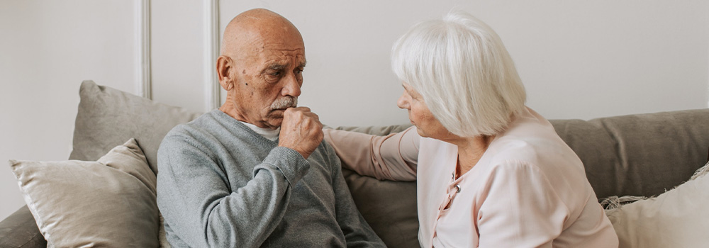 old man and woman on couch