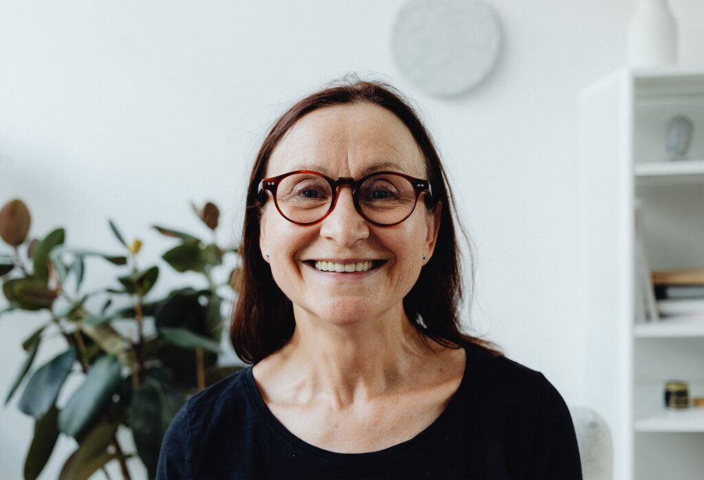 An Elderly Woman Smiling while Wearing Eyeglasses