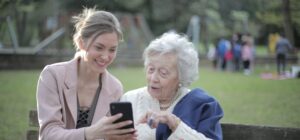 elderly woman with young woman learning technology