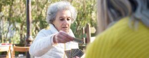 woman playing cards in park