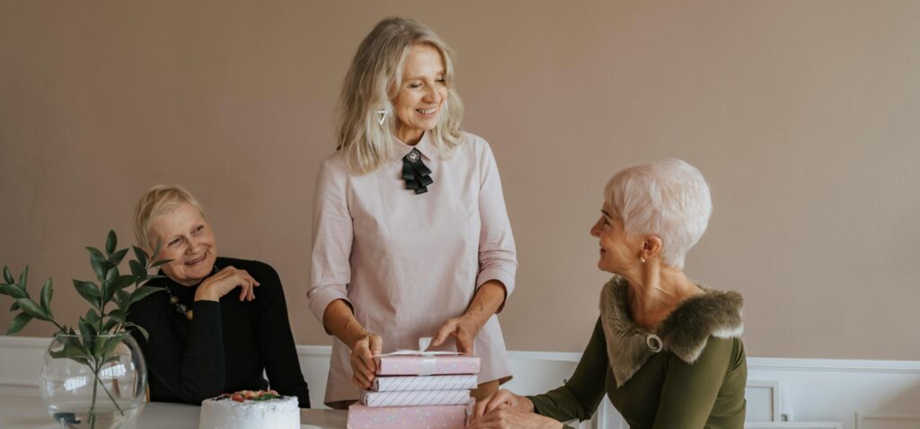 Photo of Elderly Women Talking Near Gifts